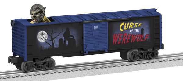 Blue boxcar with image of werewolf walking in graveyard with full moon behind. Curse of the Werewolf is written on it. Werewolf head bobbs up and down in the roof of boxcar